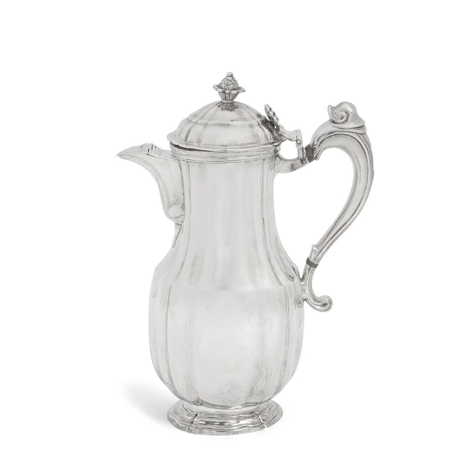 An late 18th century Spanish silver ewer makers mark C.O.O, Barcelona: An late 18th century Spanish silver ewer makers mark C.O.O, Barcelona Low bellied form, with plain fluted cover and body, the cover with bud finial and shell thumbpiece, with hinged cover to spout and