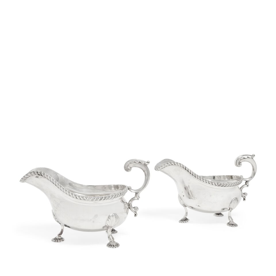 A pair of 18th century style silver sauceboats Charles Stuart Harris, London 1924 (2): A pair of 18th century style silver sauceboats Charles Stuart Harris, London 1924 Oval bellied form with gadroon rim, leaf-capped flying scroll handle, on three shell-capped feet, length 20cm, weight 