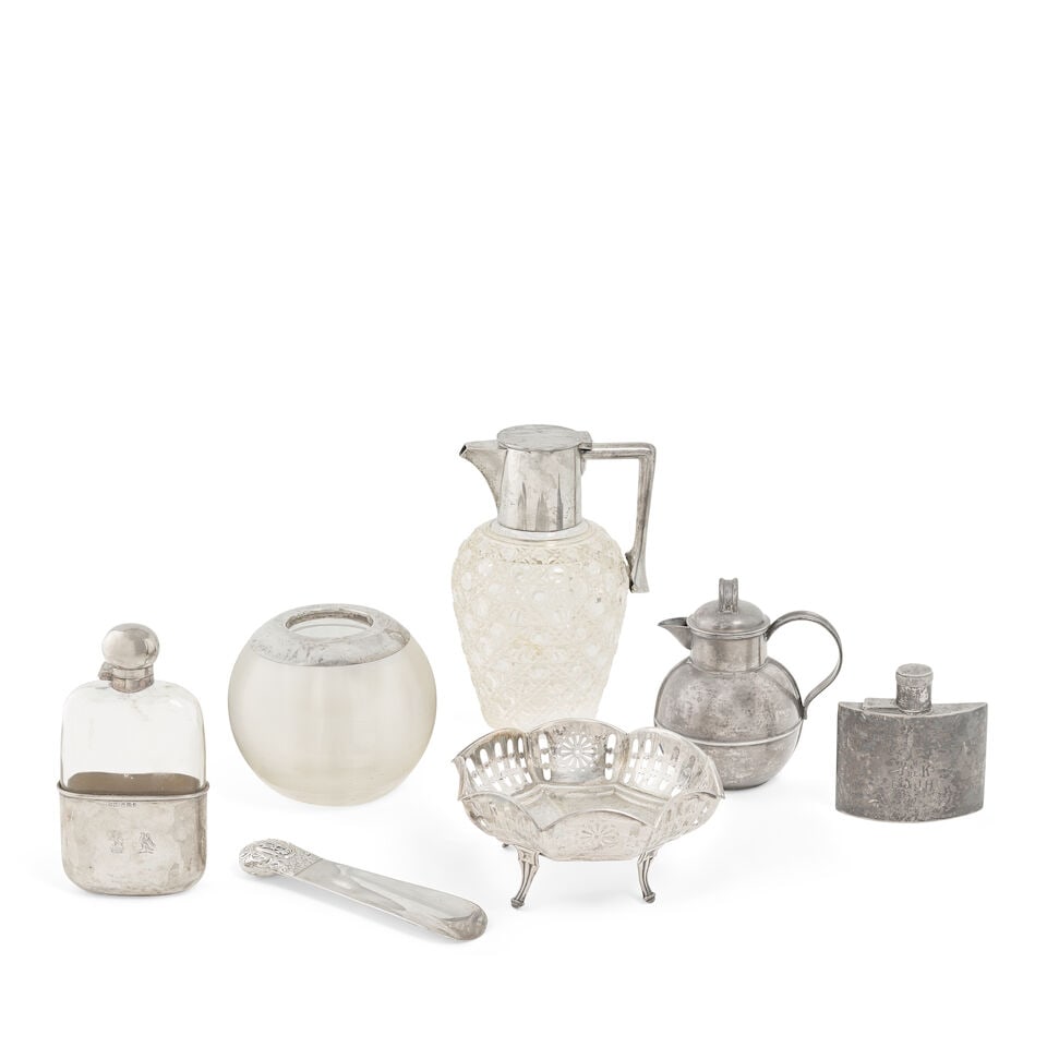 An Edwardian silver-mounted glass claret jug and a collection of silver items John Grinsell & So...: An Edwardian silver-mounted glass claret jug and a collection of silver items John Grinsell & Sons, London 1904 With plain collar and angular handle, cut glass body, height 19.5cm; together with other
