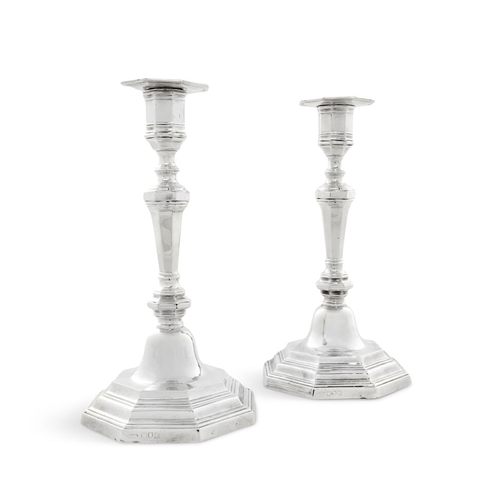 A pair of silver candlesticks Goldsmiths & Silversmiths Co Ltd, London 1910: A pair of silver candlesticks Goldsmiths & Silversmiths Co Ltd, London 1910 Tapering octagonal form, with knopped stem on a spreading stepped bases, loaded, height 23cm. For further information on thi