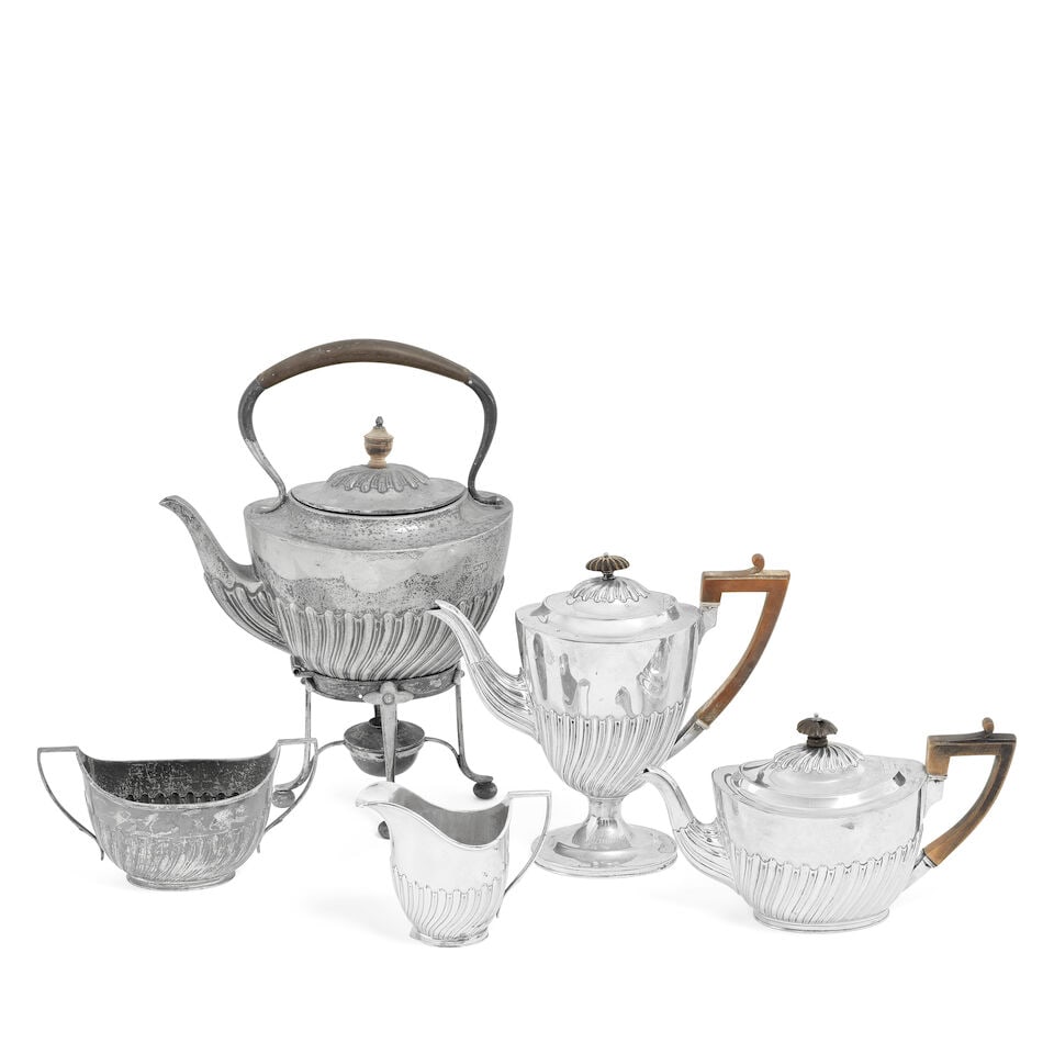 A Victorian silver five-piece tea service including kettle on stand Alfred Benson & Henry Hugh W...: A Victorian silver five-piece tea service including kettle on stand Alfred Benson & Henry Hugh Webb (Hunt & Roskell), London 1895, coffee pot 1893 Oval form, with spiral fluted lower body, each engrav