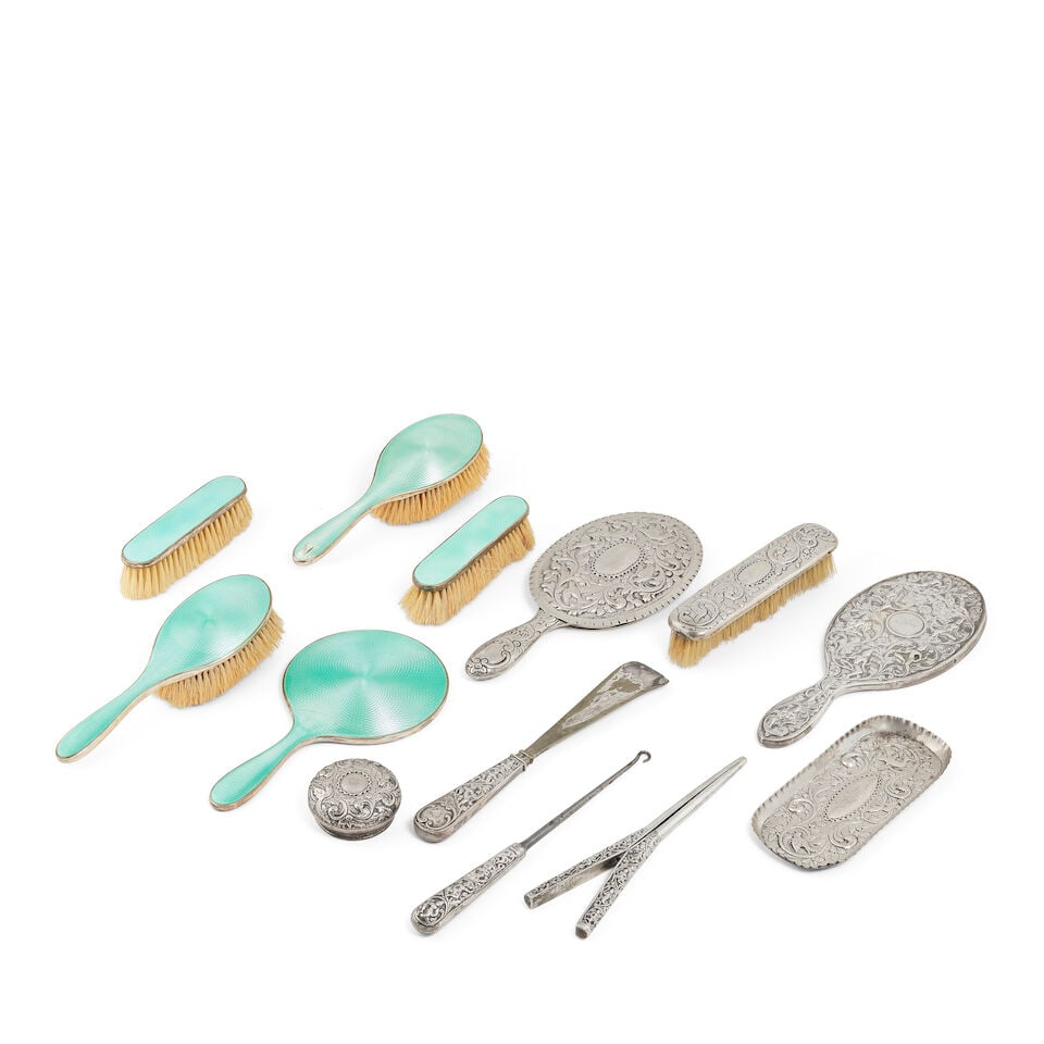 A collection of silver dressing table items, including an Indian silver hand mirror, glove stret... (1 of 1)