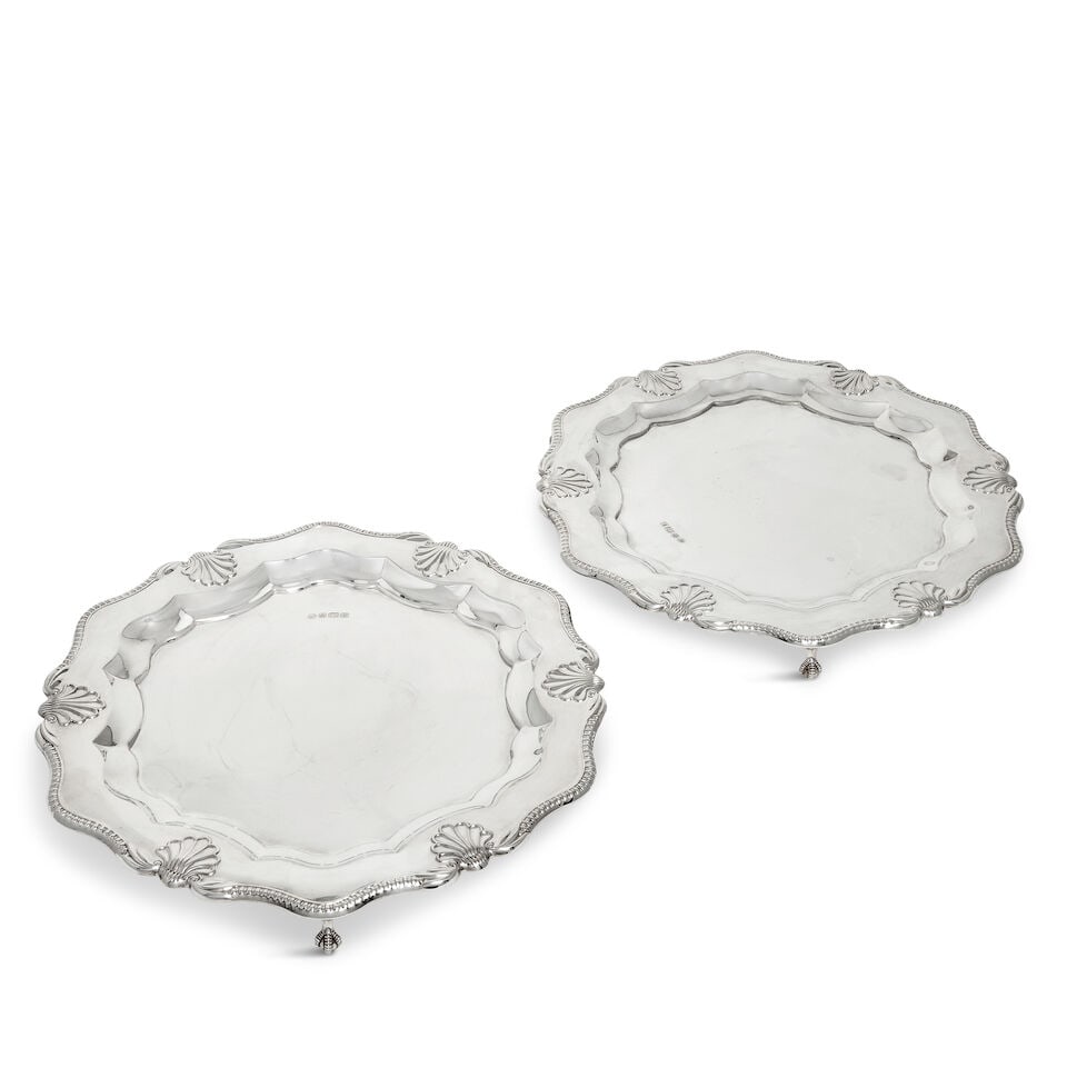 Two silver salvers R Carr's of Sheffield Ltd, Sheffield 1998 (2): Two silver salvers R Carr's of Sheffield Ltd, Sheffield 1998 Shaped-circular with gadroon and large shell border, on three claw and ball feet, diameter 30.3cm, weight 54oz. (2) For further information