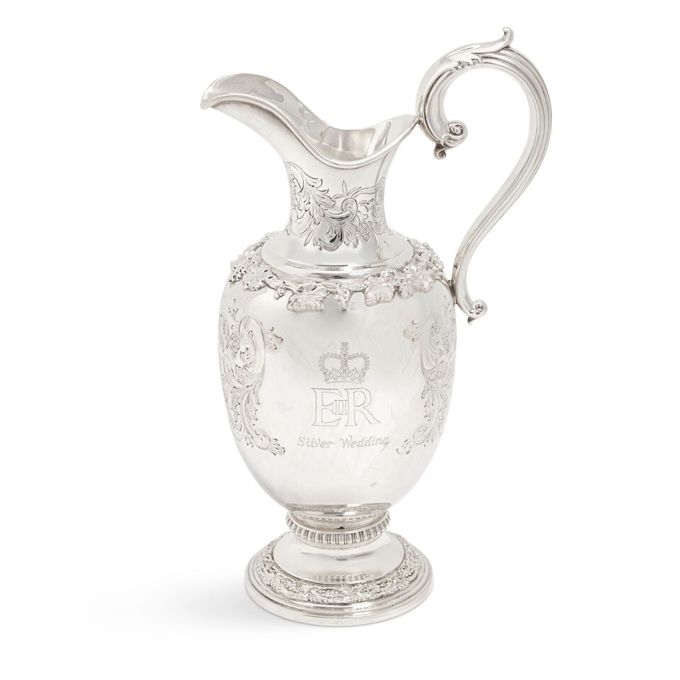 A cased modern silver commemorative ewer Garrard & Co Ltd, London 1973: A cased modern silver commemorative ewer Garrard & Co Ltd, London 1973 To commemorate the Silver Wedding of Queen Elizabeth II and Prince Phillip, ovoid form with waisted neck, on circular bases,