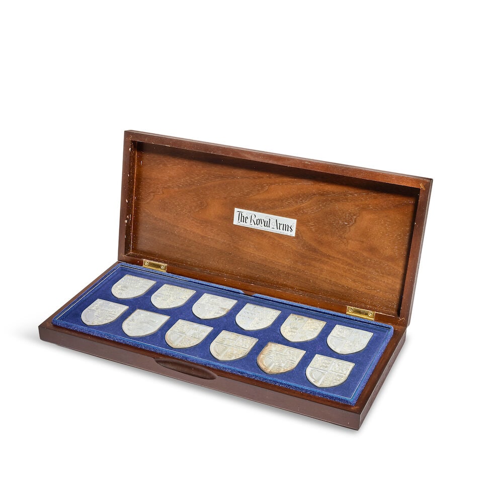 A cased set of twelve silver 'The Royal Arms' shield ingots maker YM, Birmingham 1976, for the D...: A cased set of twelve silver 'The Royal Arms' shield ingots maker YM, Birmingham 1976, for the Danbury mint, in a fitted box, weight 18.6oz. For further information on this lot please visit