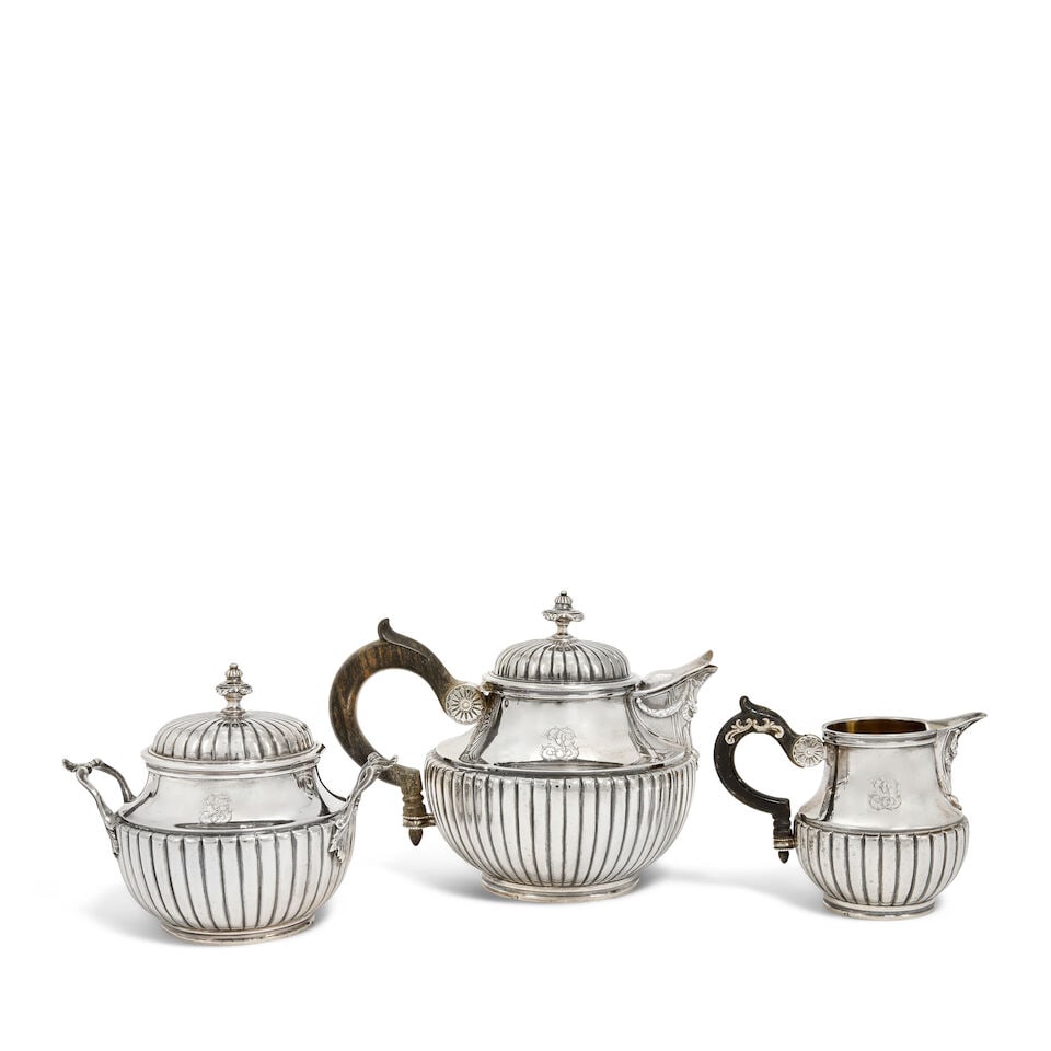 A 19th century French silver three-piece tea service Maison Odiot, with first standard Minerva mark: A 19th century French silver three-piece tea service Maison Odiot, with first standard Minerva mark Baluster form, each with fluted lower bellies, the covers with repeated fluting with urn finials, wi