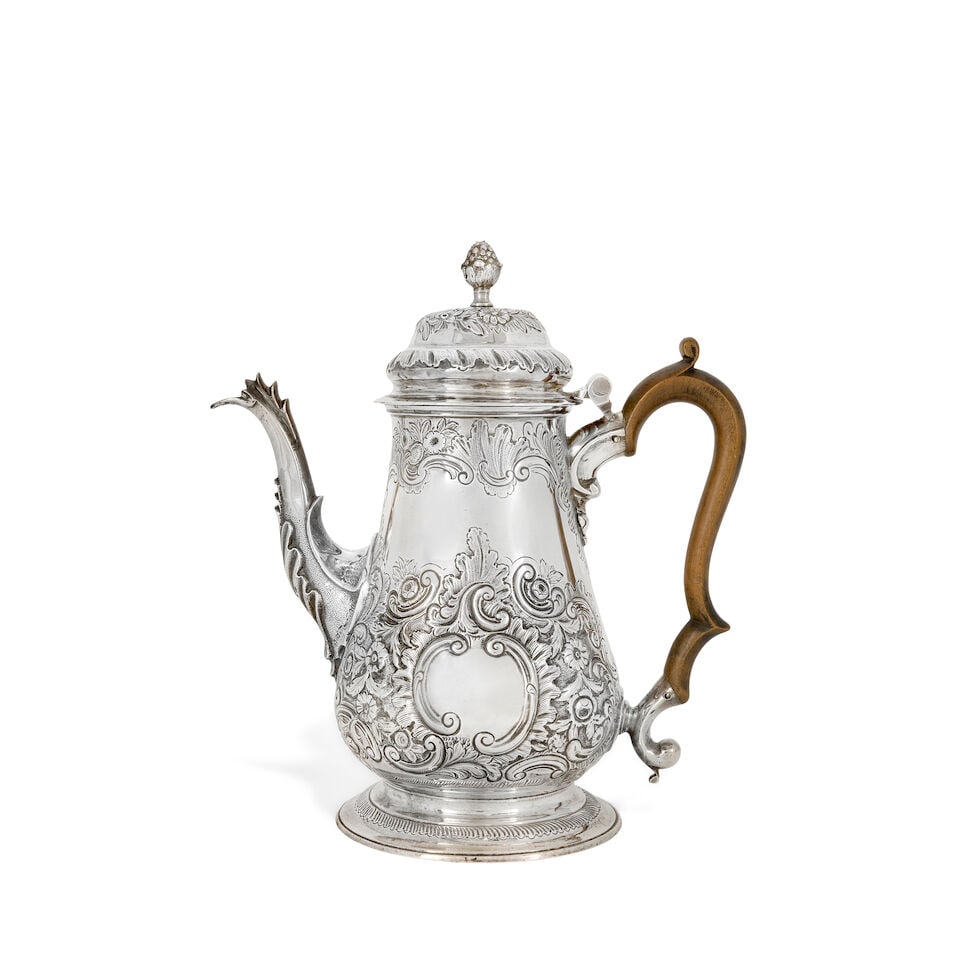A George III silver coffee pot Thomas Whipham & Charles Wright, London 1764: A George III silver coffee pot Thomas Whipham & Charles Wright, London 1764 Tapering form, hinged dome cover with bud finial, foliate chased sides with C scrolls and flora, blank cartouche either side