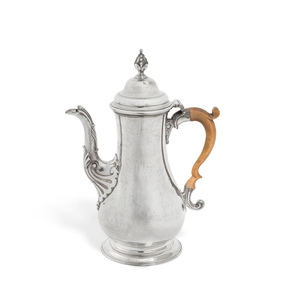 A George III silver coffee pot William Cripps, London 1761: A George III silver coffee pot William Cripps, London 1761 Plain baluster form, hinged dome cover, with bud finial, wood handle, spout embellished with flutes and scrolls, height 27.7cm, weight total 