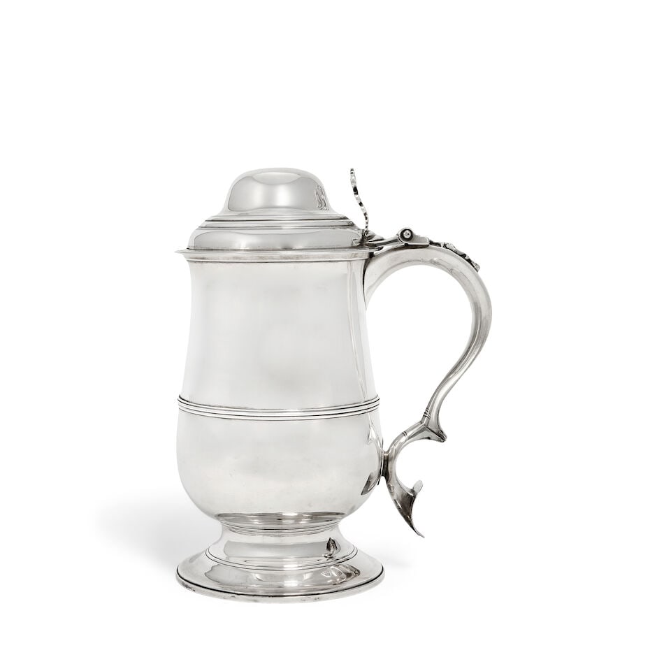 A George III silver tankard George Smith (II) & Thomas Hayter, London 1797: A George III silver tankard George Smith (II) & Thomas Hayter, London 1797 Baluster form, hinged cover with open-work scroll thumb piece, with applied girdle , with scroll handle with heart shaped ter