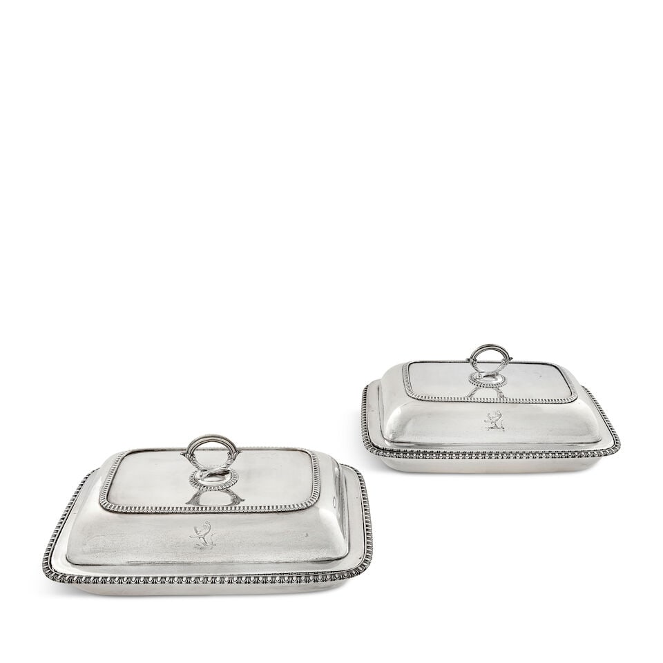 A pair of George III silver entrée dishes and covers maker's mark WB, probably William Ben...: A pair of George III silver entrée dishes and covers maker's mark WB, probably William Bennett London 1808 Rectangular form with rounded corners, lappet borders, engraved crest to cover and bases