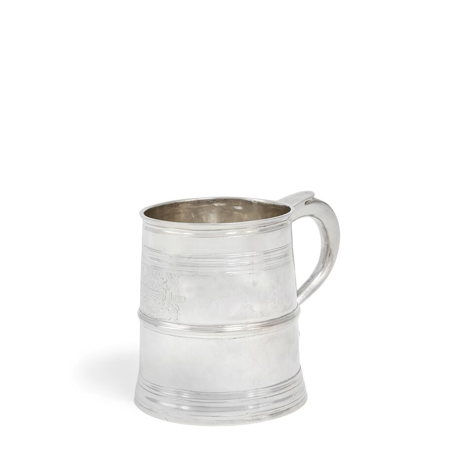 A Queen Anne Britannia standard silver mug Robert Lovell, London 1705: A Queen Anne Britannia standard silver mug Robert Lovell, London 1705 Of tapering form, with applied girdle, engraved with the arms of JACOBSEN with stepped foot, height 9.2cm, weight 7.8oz. Footnotes