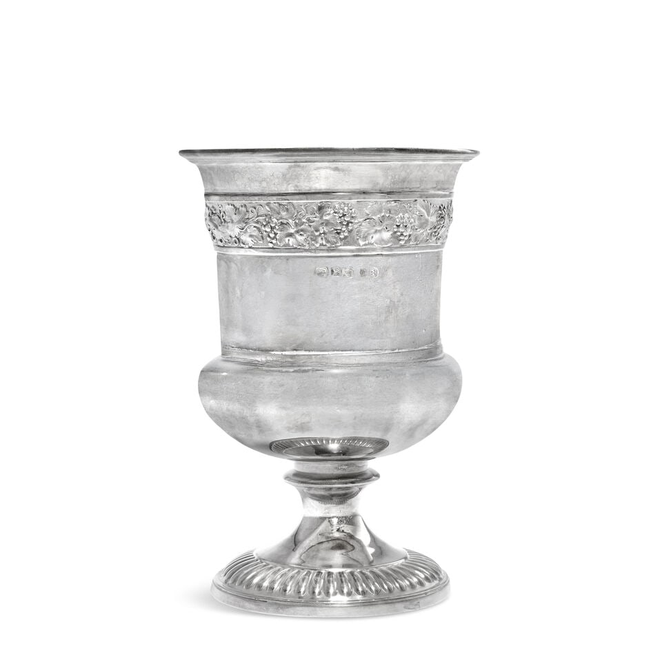 A George III silver goblet Paul Storr, London 1811: A George III silver goblet Paul Storr, London 1811 Campana form with moulded rim, embossed and chased fruiting vine band below, the spreading foot with fluted band, gilt interior, height 15.2cm, weigh