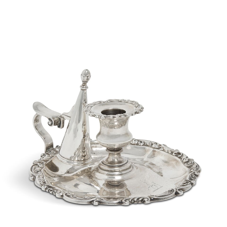 A William IV silver chamberstick Paul Storr, London 1832, also stamped STORR & MORTIMER, also st...: A William IV silver chamberstick Paul Storr, London 1832, also stamped STORR & MORTIMER, also stamped number to base Shaped-circular base with acanthus scroll rim, with engraved crest, central nozzle 