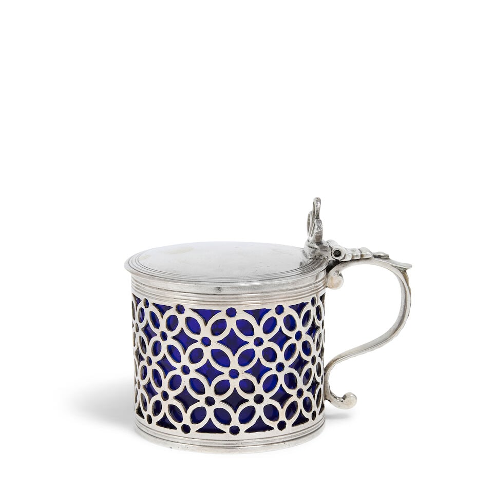 A George III silver drum mustard pot Samuel Herbert & Co, London 1764, with Dutch 1814-1893 impo...: A George III silver drum mustard pot Samuel Herbert & Co, London 1764, with Dutch 1814-1893 import mark Cylindrical form, with flat cover with openwork triform thumbpiece, with scroll handle, with pie