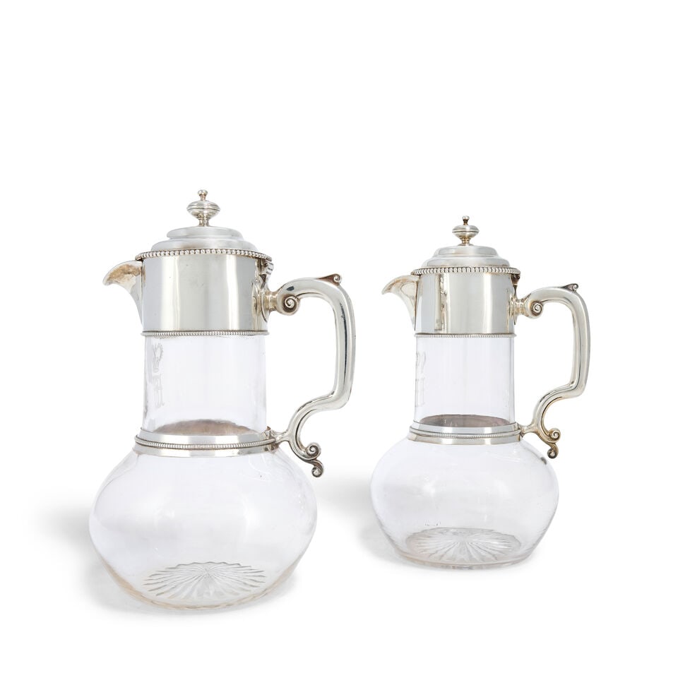 A near pair of Victorian silver-mounted glass claret jugs John Figg, London 1857 and 1860, also ...: A near pair of Victorian silver-mounted glass claret jugs John Figg, London 1857 and 1860, also incused stamped 2126 and 3453 Each with clear glass bodies engraved with etched crowned monogram to the 
