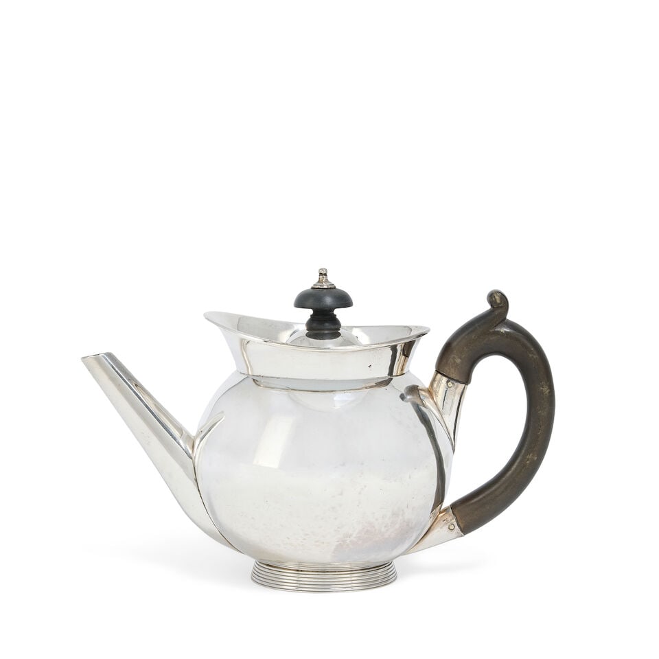 A Victorian silver tea pot Frazer & Haws, London 1874: A Victorian silver tea pot Frazer & Haws, London 1874 Bullet form, with flared collar rim, with domed cover with turned wooden finial, with wooden looped handle, raised on ribbed spreading foot, heigh