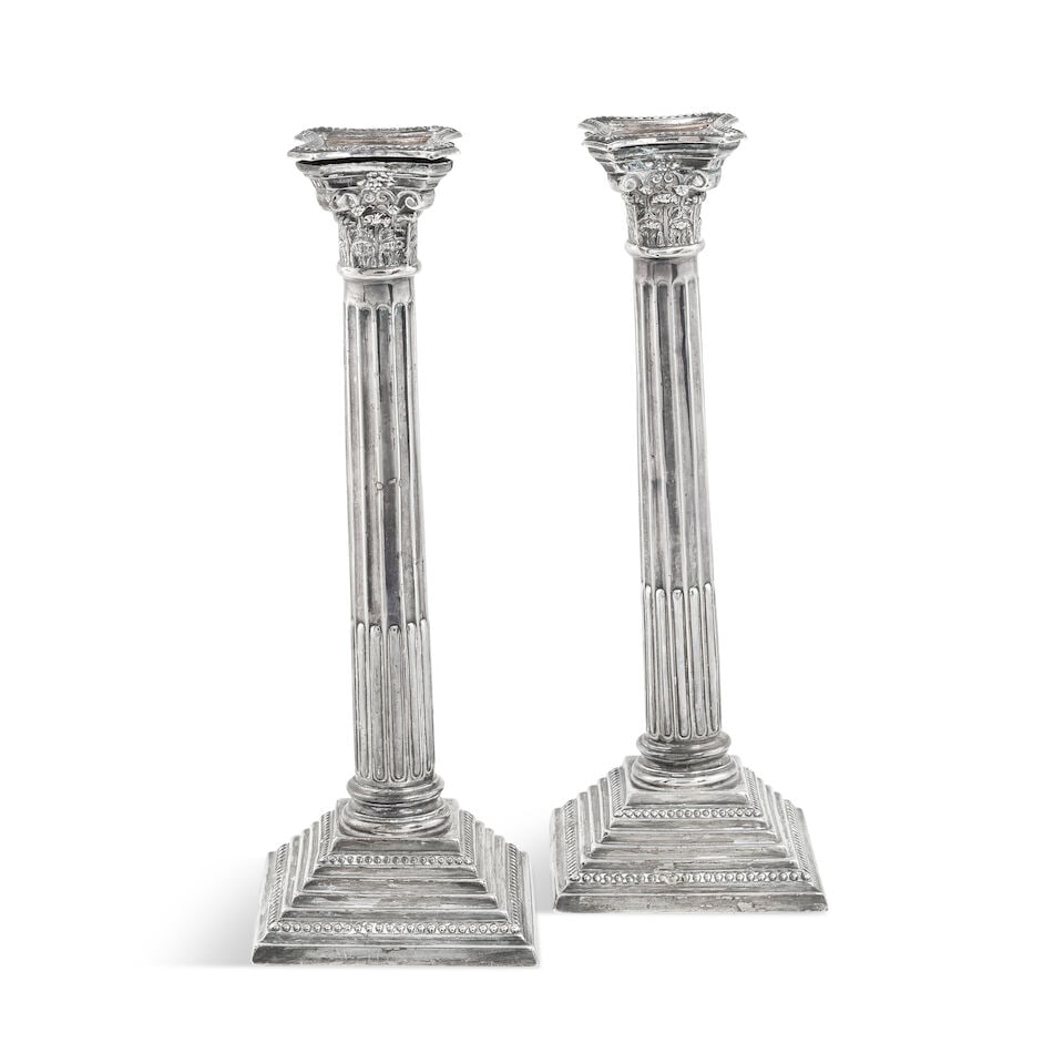 A pair of silver candlesticks makers mark rubbed, Birmingham 1931: A pair of silver candlesticks makers mark rubbed, Birmingham 1931 Detachable drip pans, with corinthian capitals, with fluted stems, raised on stepped and beaded bases, height 28.6cm, weight 22oz. For