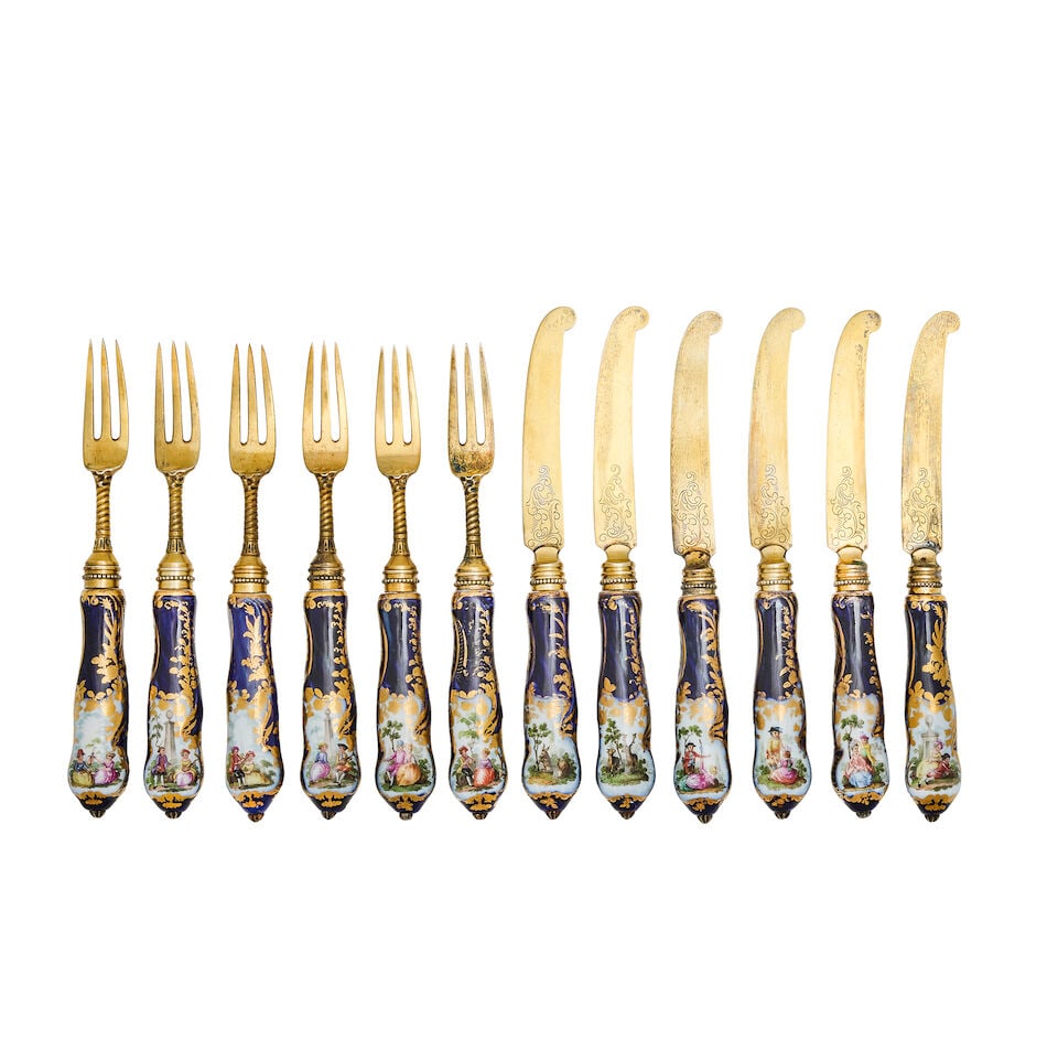 A Continental dessert service with French swan import mark: A Continental dessert service with French swan import mark With porcelain handles decorated with Watteau-esq scenes, with silver gilt blades and tines. For further information on this lot please visit