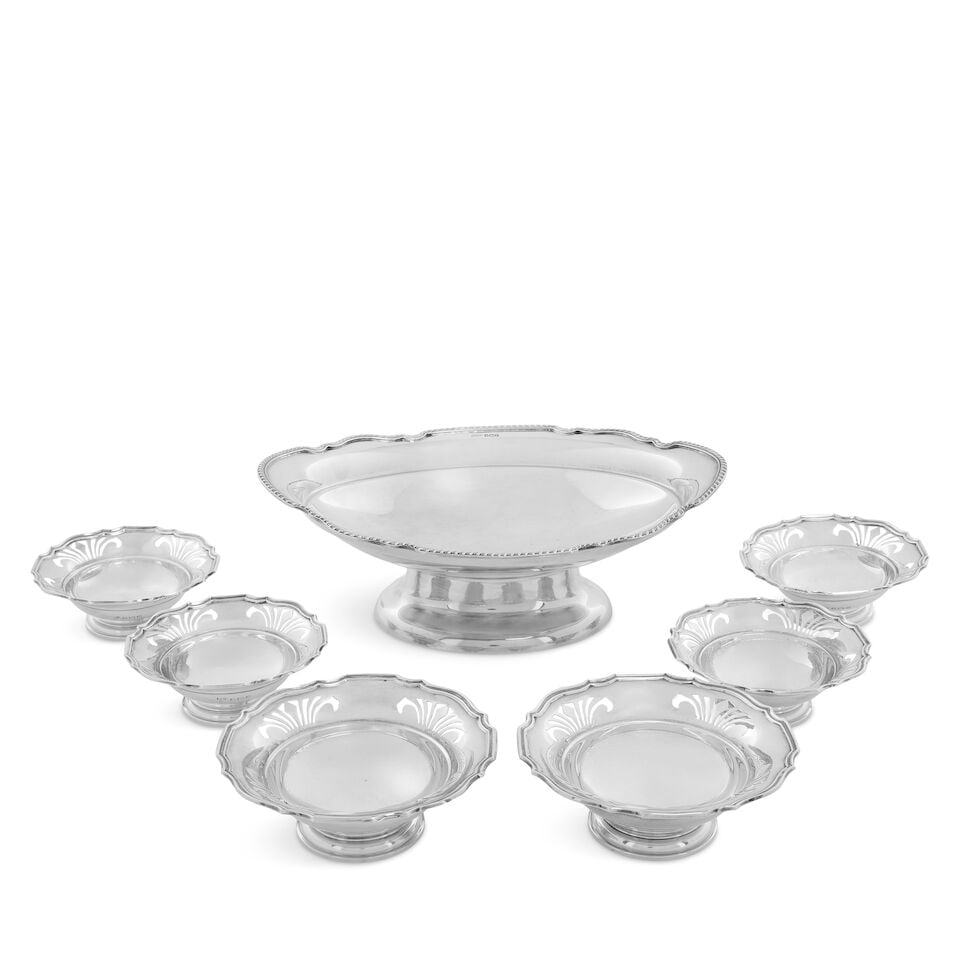 A collection of silver dishes (7): A collection of silver dishes Comprising a suite of six pierced dishes, Richard Woodman Burbridge, Birmingham 1913, two large and four smaller, shaped-circular with pierced borders, diameter 12.5cm an