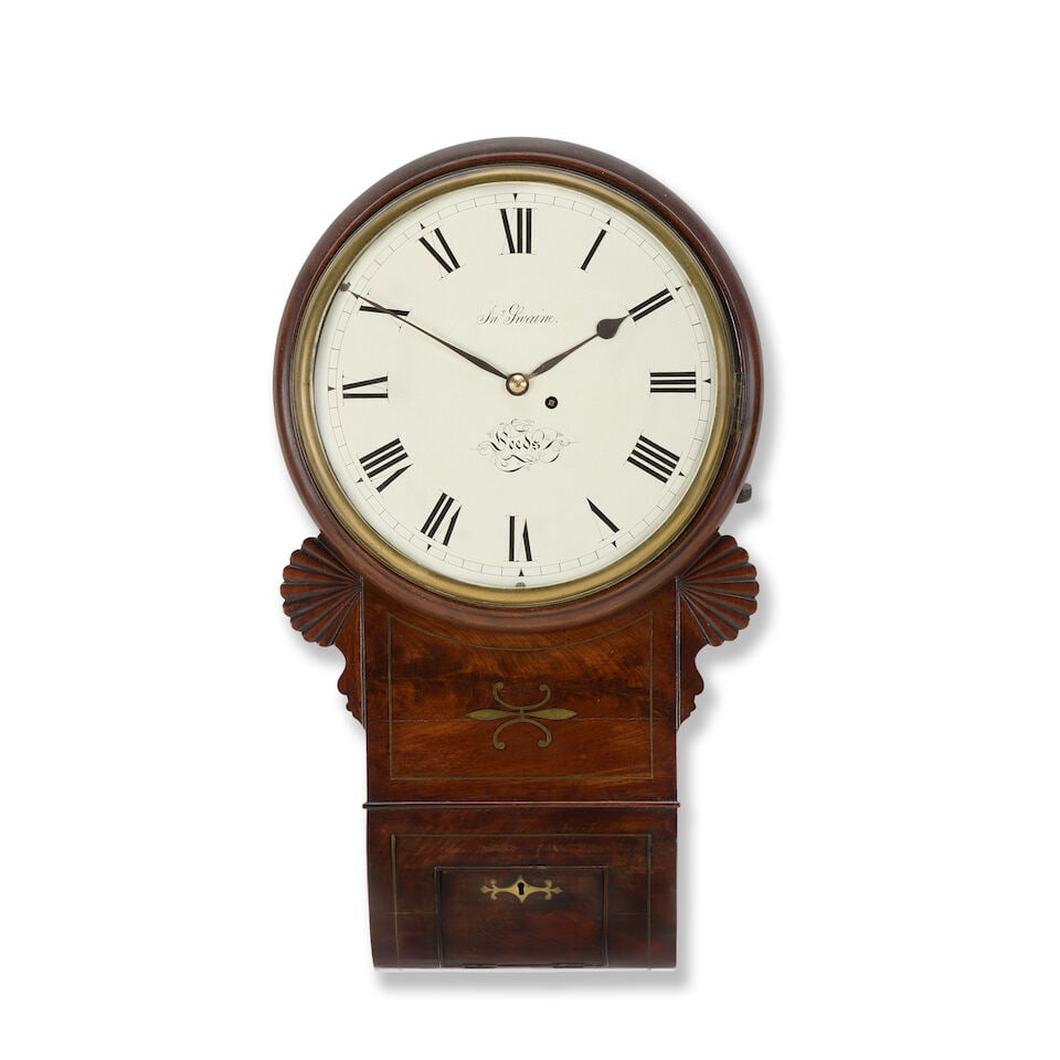 A large Regency mahogany and brass inlaid drop dial timepiece The dial signed John Swaine, Leeds: A large Regency mahogany and brass inlaid drop dial timepiece The dial signed John Swaine, Leeds The case with carved wings to the sides with brass inlay to the centre behind a well-figured mahogany f