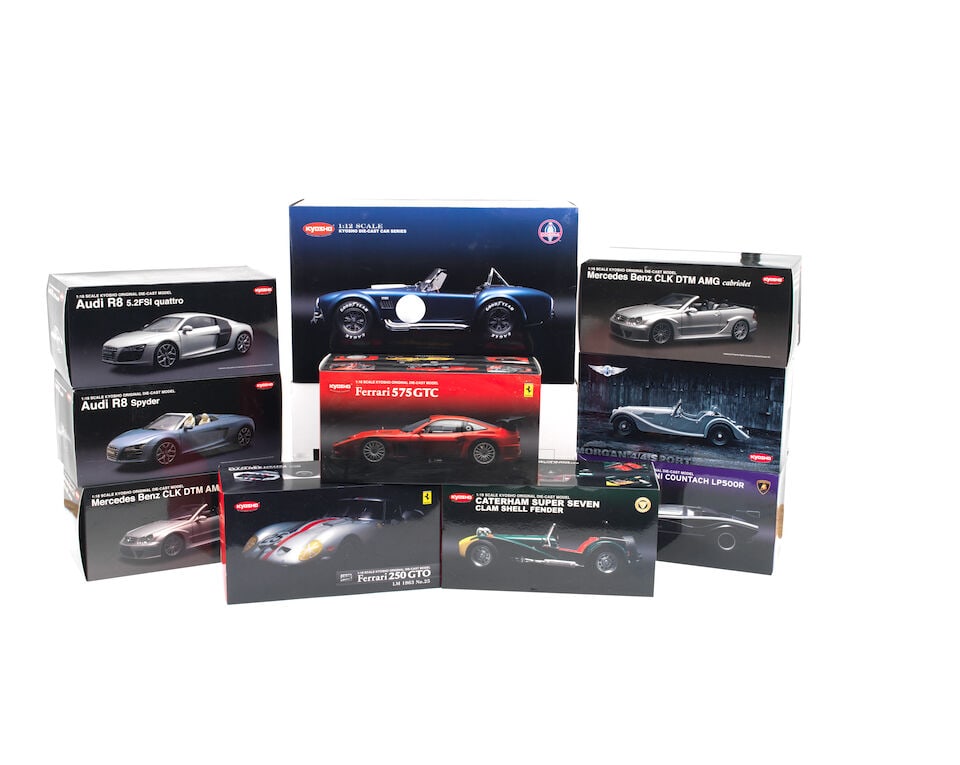 A boxed 1:12 scale die-cast model of a Shelby Cobra 427 S/C by Kyosho of Japan, ((10)): A boxed 1:12 scale die-cast model of a Shelby Cobra 427 S/C by Kyosho of Japan, model No.08631BL, depicting the car in metallic blue race livery, boxed with sealed styrene packing, and with outer cart