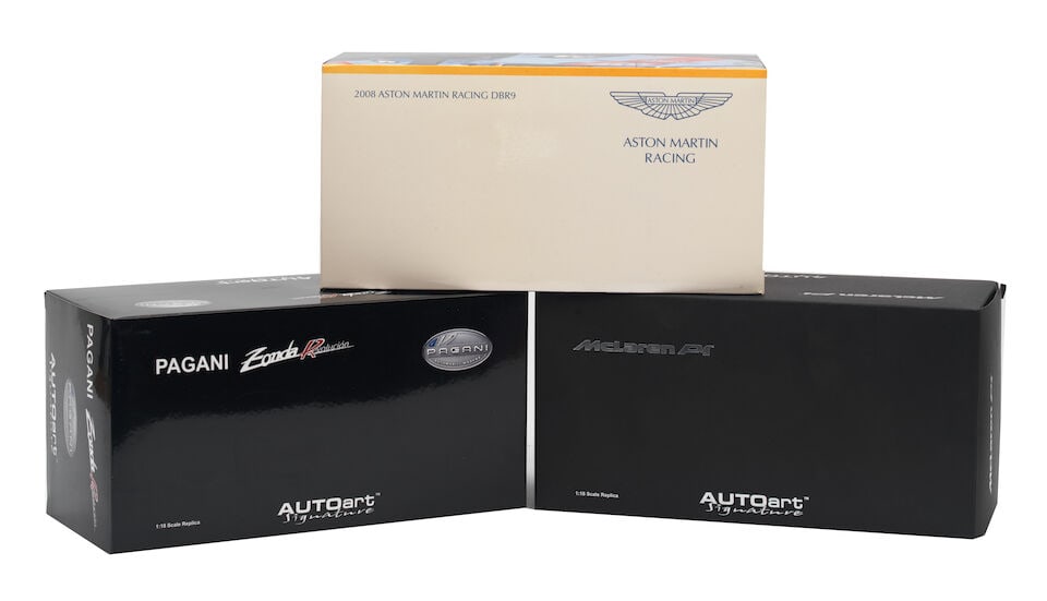 Three boxed 1:18 scale die-cast models of McLaren P1, Pagani Zonda and Aston Martin DBR 9 by Aut...: Three boxed 1:18 scale die-cast models of McLaren P1, Pagani Zonda and Aston Martin DBR 9 by Autoart, comprising Pagani Zonda Revolucion (1442), in white livery; and McLaren P1 (0204), in Ice Silver l