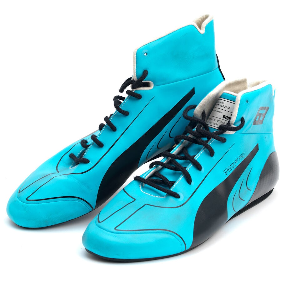 A pair of 2024 George Russell Puma racing boots,: A pair of 2024 George Russell Puma racing boots, in blue with wear and tear from use. For further information on this lot please visit Bonhams.com For further information about this lot please