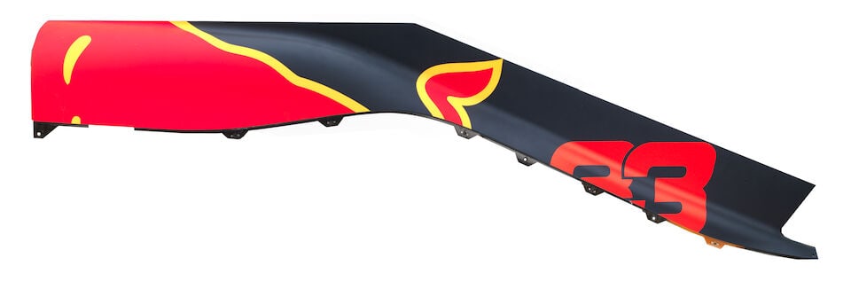 A 2018 Red Bull RB14 Spine from Max Verstappen's car,: A 2018 Red Bull RB14 Spine from Max Verstappen's car, carbon fibre, in blue and red, signs of wear, numbered RB14-BE-00203-01#103 to underside, approximately 145cm long. For further information on