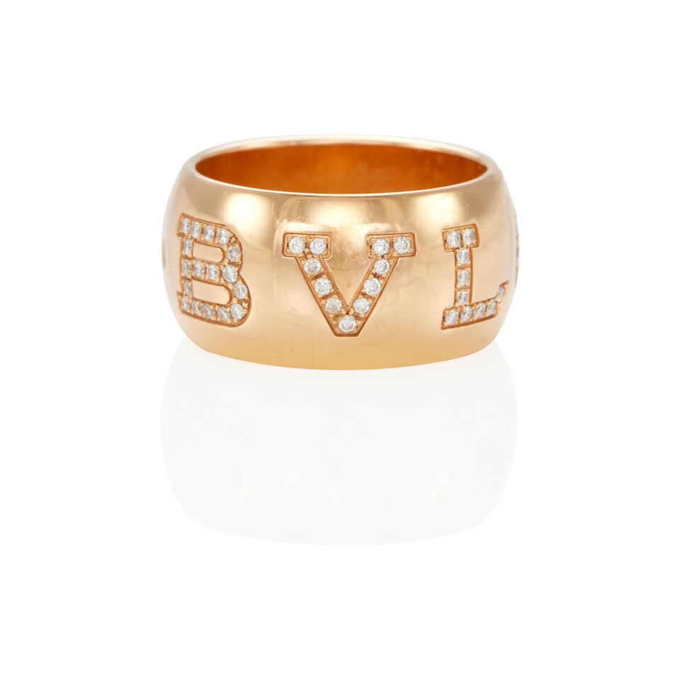 BULGARI: 18K GOLD AND DIAMOND BAND RING: BULGARI: 18K GOLD AND DIAMOND BAND RING • 18k yellow gold • Numerous round diamonds weighing approximately 0.40 - 0.50 carat total • Signed BVLGARI • Size 5 1/4 •