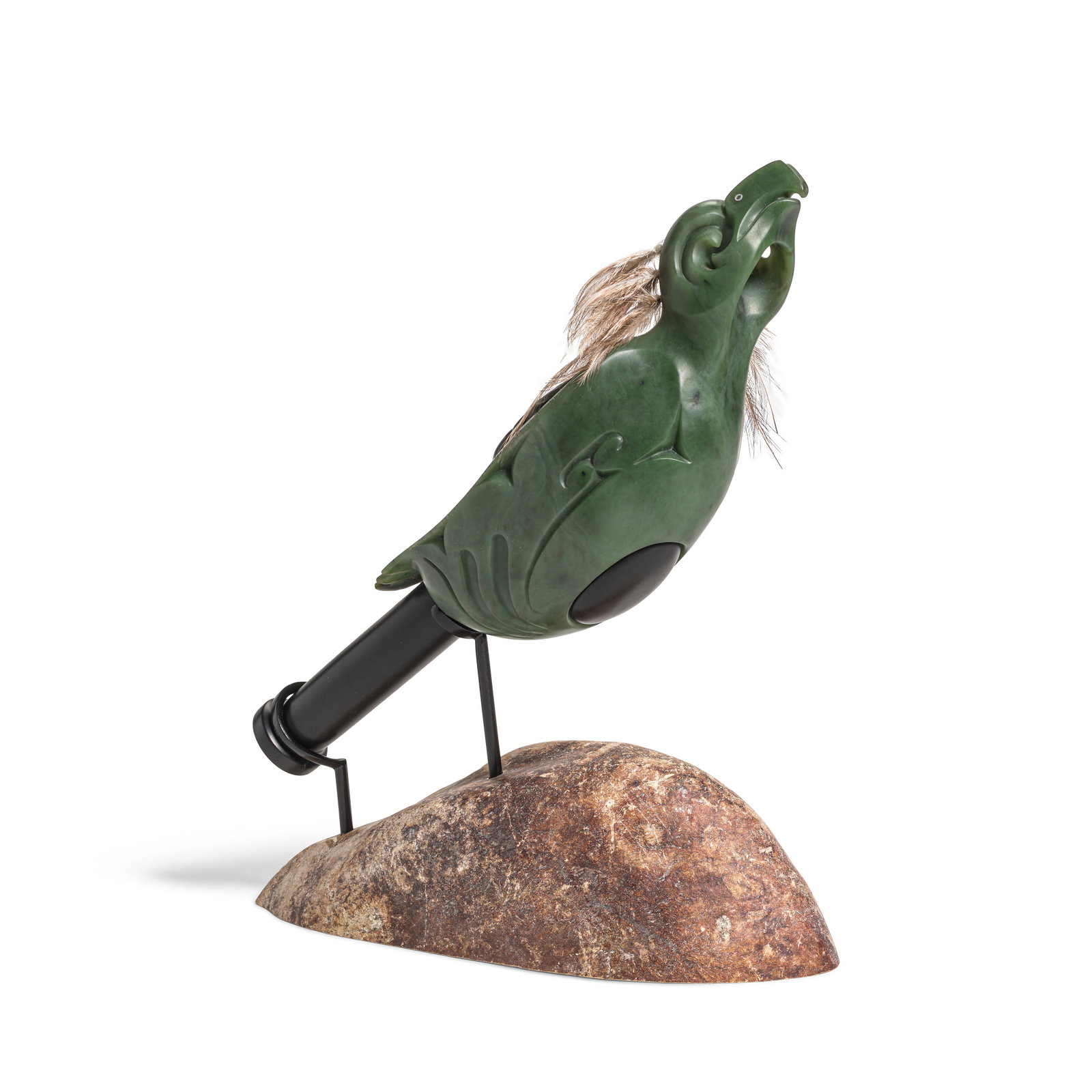 A Lewis Tamihana Gardiner pounamu greenstone bird rattle: Lewis Tamihana Gardiner Māori, (b. 1972), untitled (bird-form rattle), carved pounamu greenstone and mixed media, mounted on a stone base, signed on the underside. length of rattle 15in; height a