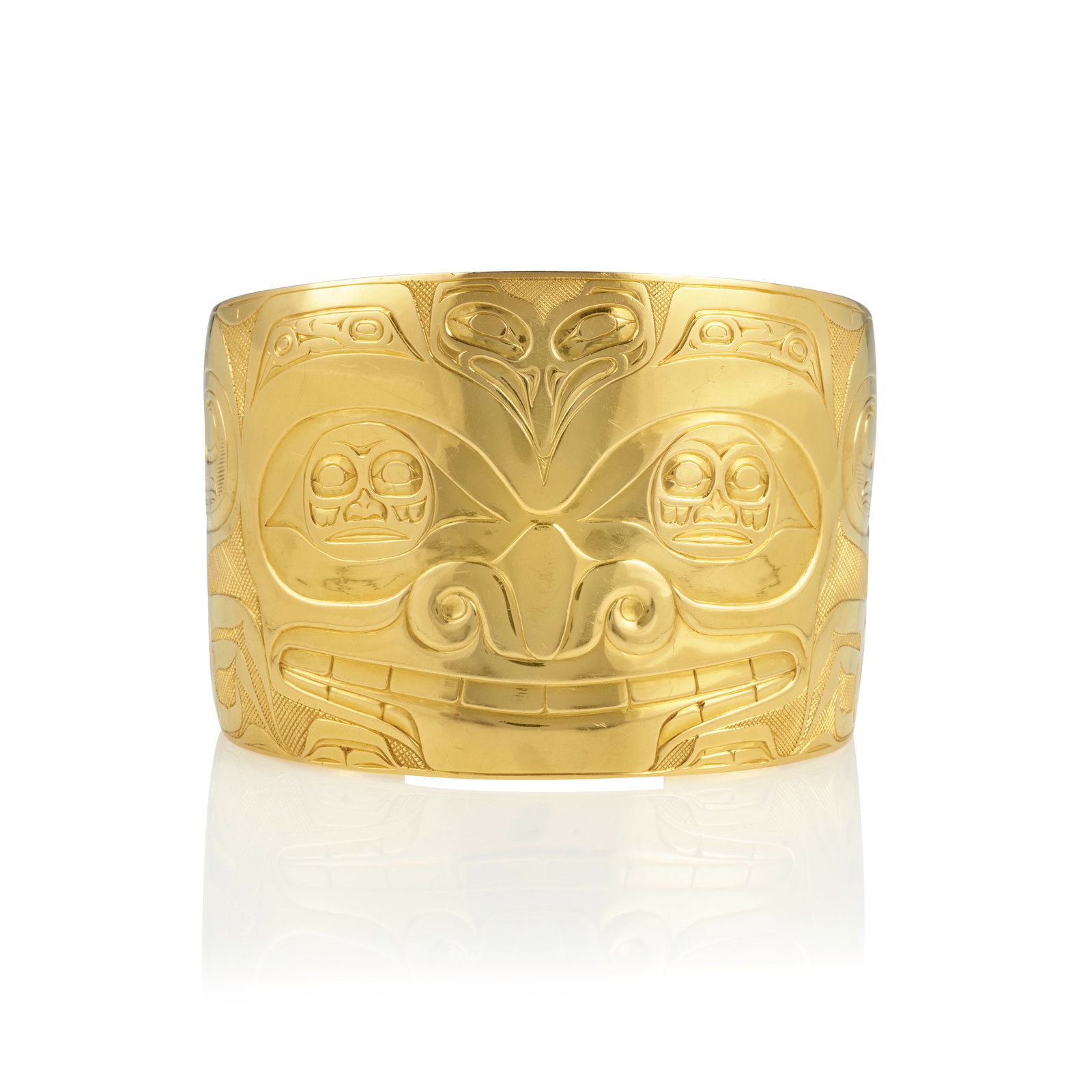 A Bill Reid gold cuff bracelet: Bill Reid (Iljuwas), O.B.C., R.C.A. Haida, (1920-1998), a wide 22k gold cuff bracelet worked with a formline grizzly bear, inscribed and signed on the interior: Haida Art / Reid, unmarked for gold pur