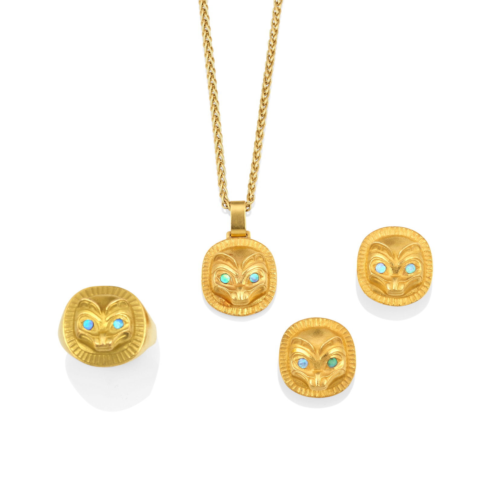 A suite of Bill Reid gold bear-motif jewelry: Bill Reid (Iljuwas), O.B.C., R.C.A. Haida, (1920-1998), a four-piece 'Bear Cub' gold jewelry suite, including a ring, a pendant, and a pair of earrings, each with inlaid eyes, each signed for maker, t