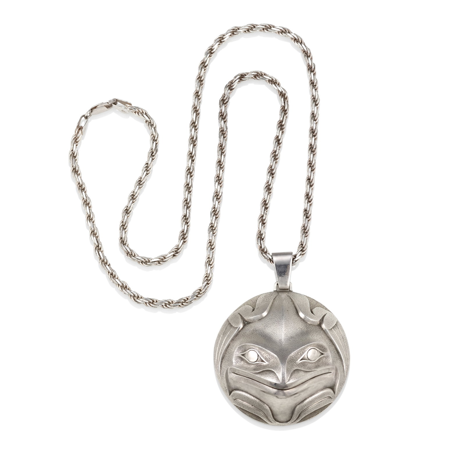 A Robert Davidson 'Frog Mask' pendant, 1982: Robert Davidson, O.C., O.B.C., R.C.A. Haida, (b. 1946), 'Frog Mask' pendant in sterling silver, 1982, edition 1 of 16, initialed, dated and numbered along the outer edge, unmarked for silver purity, t