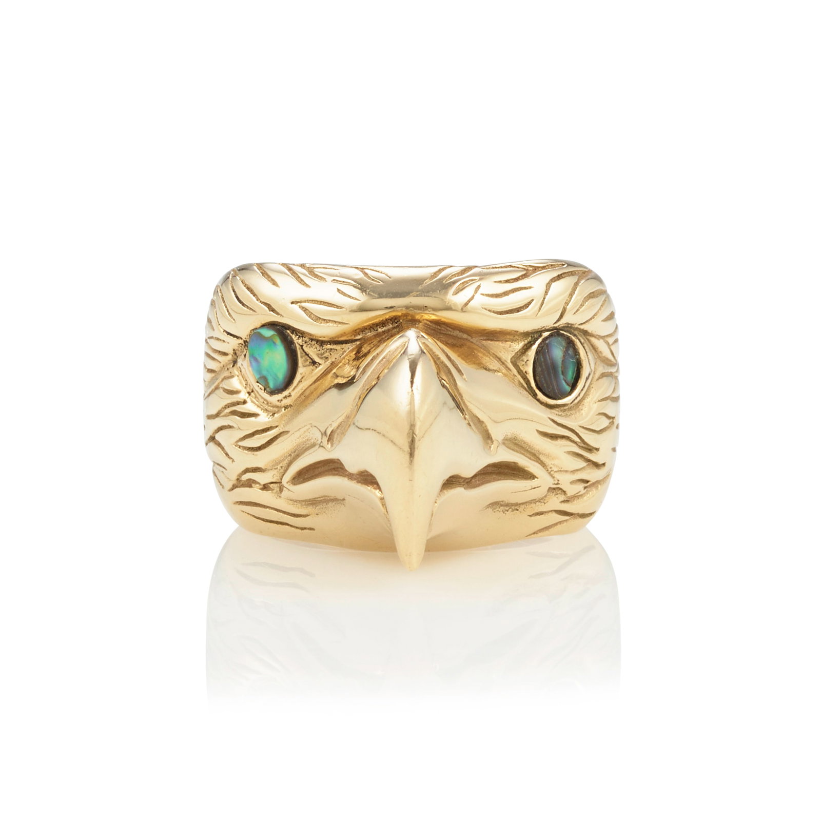 A Simon Dick 14k gold eagle-motif ring: Simon Dick Kwakwaka'wakw (Kwakiutl), (b. 1951), a 14k gold ring with inlaid eyes, depicting the head of an eagle, signed with artist's conjoined initials on interior of shank: SD, stamped: 14k. ring s