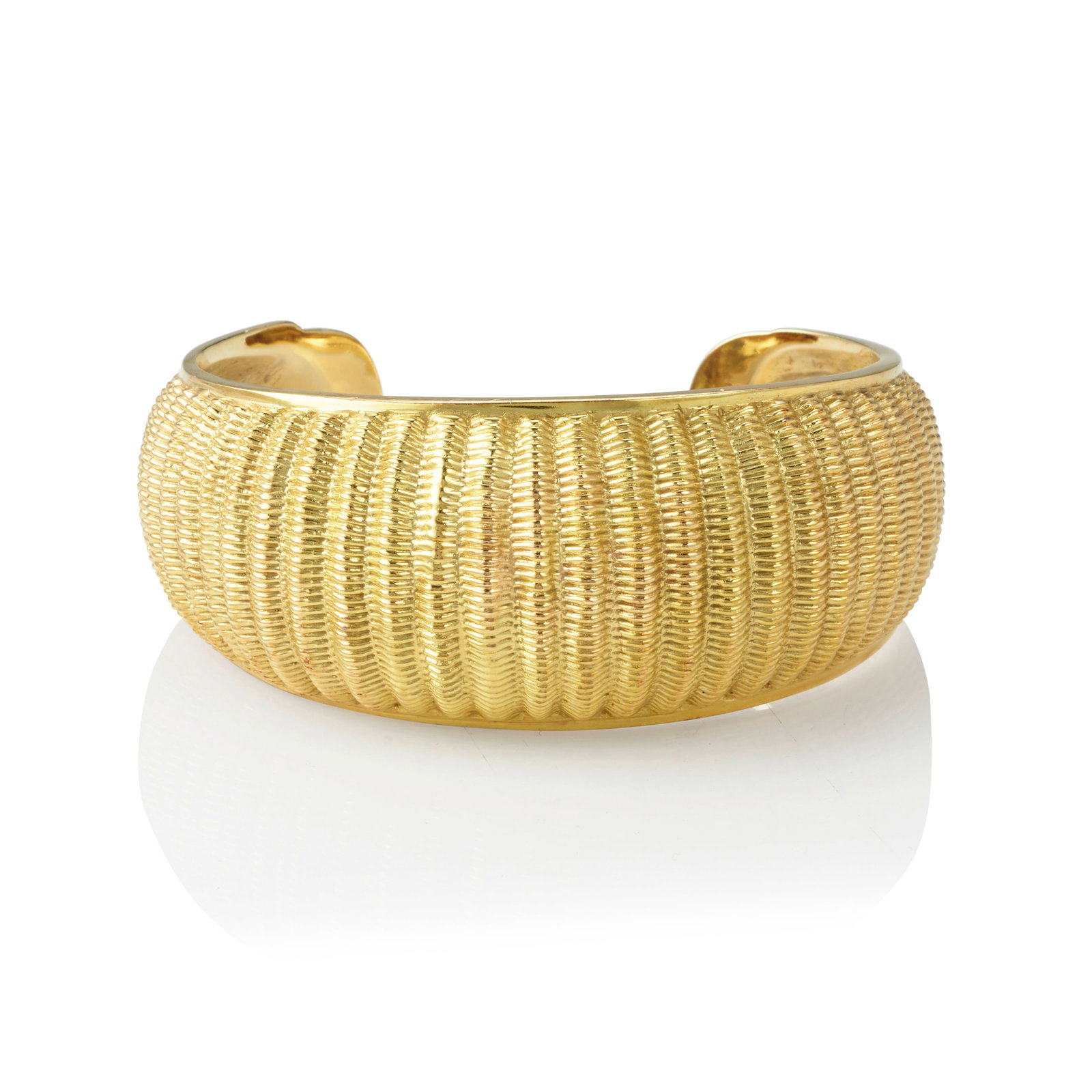 A Harvey Begay basketweave-motif gold cuff bracelet: Harvey Begay Diné (Navajo), (1939-2009), a 14k gold basketweave-texture cuff bracelet of convex design, the interior stamped with maker's mark and: 14k. interior circumference (including gap) 7in
