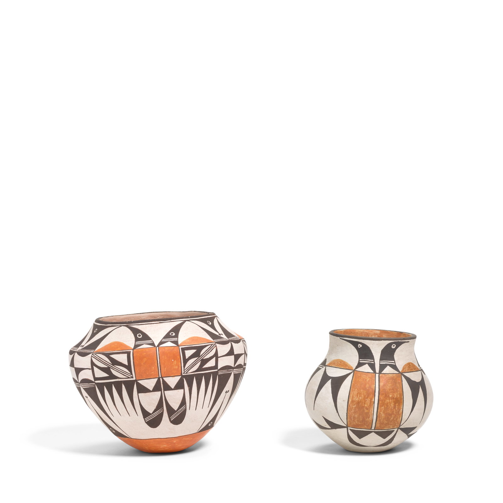 Two Lucy Lewis polychrome pottery jars: Lucy M. LewisAcoma Pueblo, (1890-1992), two polychrome pottery jars, each worked with abstract avian devices, each signed on the underside: Lucy M. Lewis. height 6in, diameter 7 1/2in and height 5