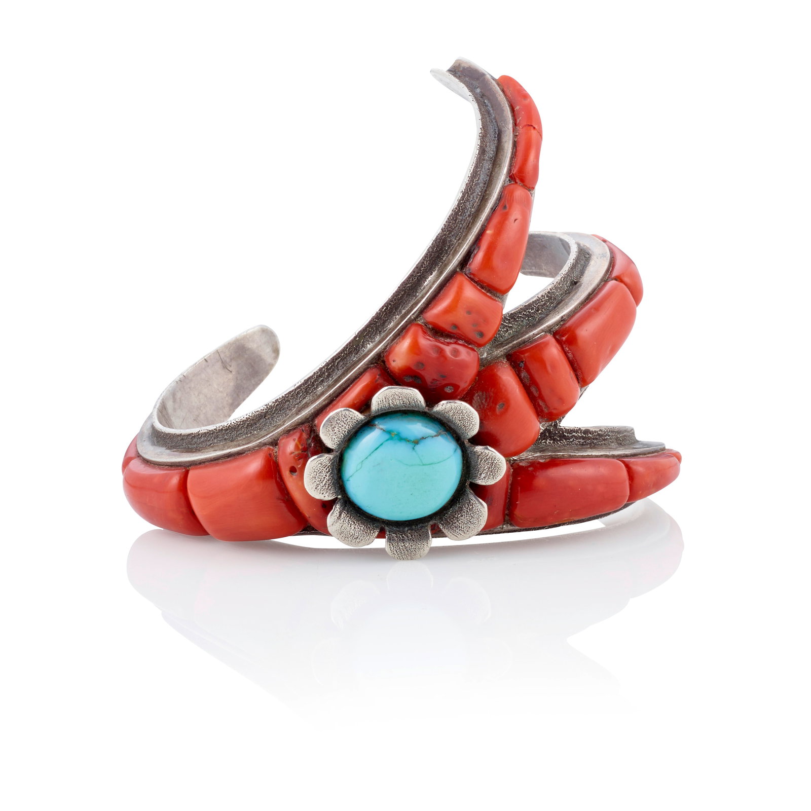 A Ben Nighthorse Campbell claw-form cuff bracelet: Ben Nighthorse Campbell Northern Cheyenne, (1933-2025) a claw-form cast silver cuff bracelet set with coral and supporting a floriform bezel set with a circular sleeping Beauty turquoise, signed with