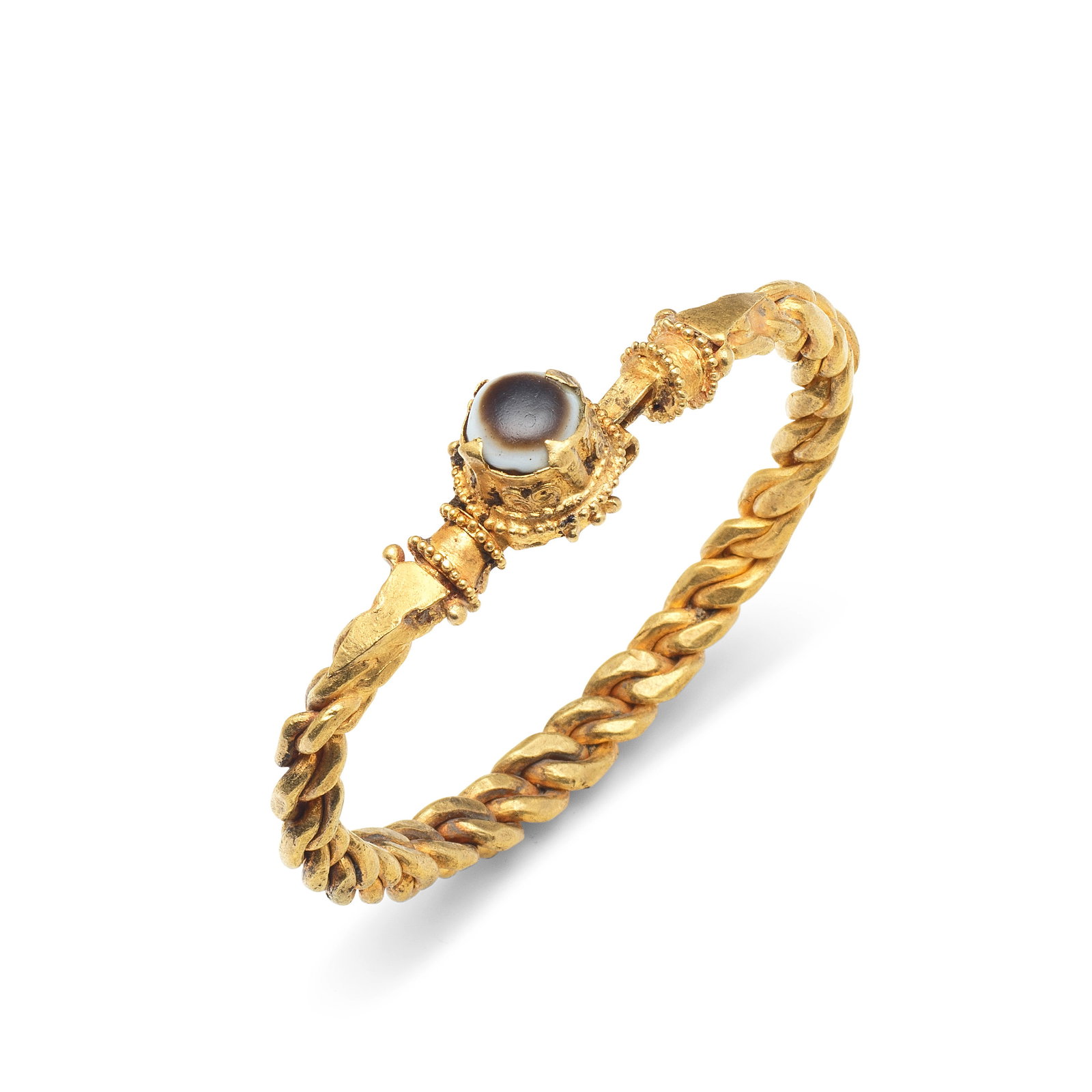 A Late Roman or Byzantine solid gold bracelet with agate cabochon: A Late Roman or Byzantine solid gold bracelet with agate cabochon Circa 4th-5th Century A.D. 7.2cm diam., weight 67g. Footnotes: Provenance with Nasli M. Heeramaneck, New York, 1960s. with Alexander