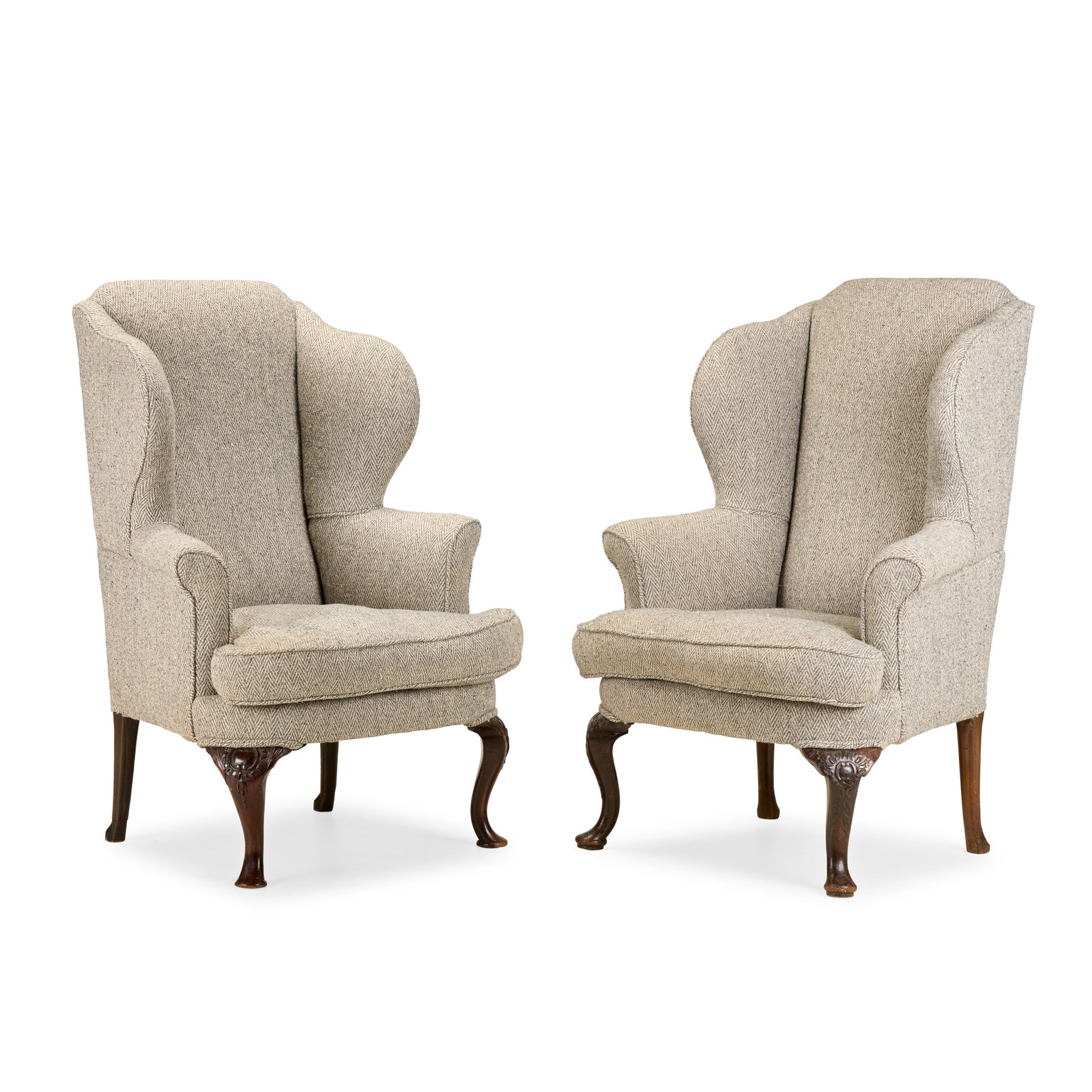 A matched pair of George II style mahogany wingback armchairsLate 19th / early 20th century (2): A matched pair of George II style mahogany wingback armchairs Late 19th / early 20th century Of typical form, on foliate and cartouche carved front cabriole legs and pad feet, upholstered in grey chev