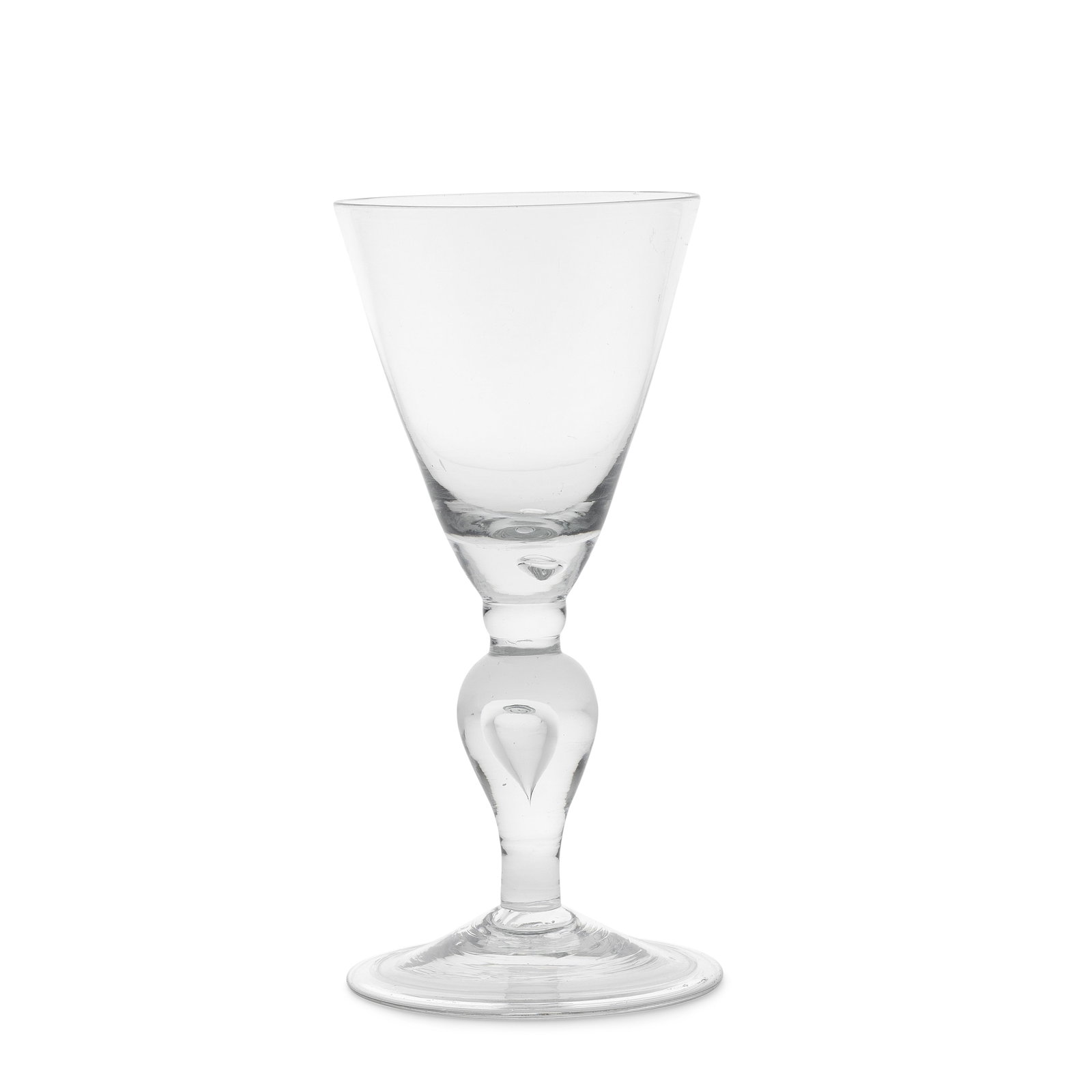 A large baluster goblet, circa 1710-15: A large baluster goblet, circa 1710-15 The generous round funnel bowl with a solid base containing a tear, resting on a small half knop above a bulbous teared inverted baluster stem, over a folded con