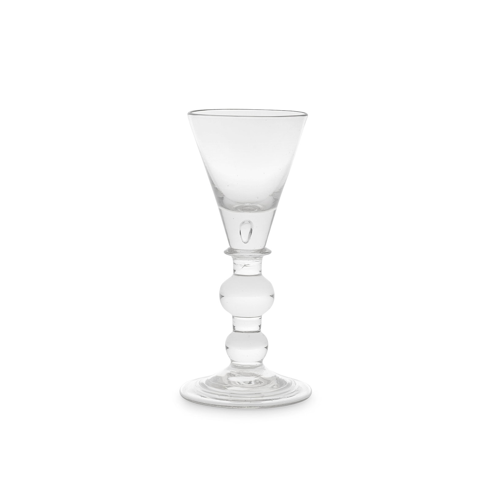 An unusual heavy baluster large wine glass or goblet, circa 1710-20: An unusual heavy baluster large wine glass or goblet, circa 1710-20 The conical bowl with a solid base containing a tear, set on a collar, the stem with a wide all knop set between short plain section