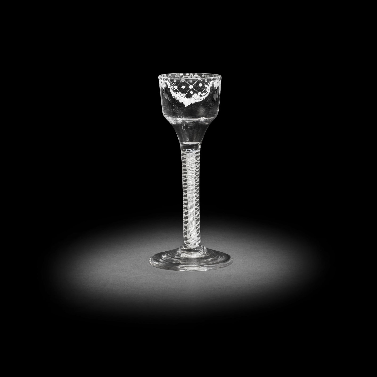 A good Beilby enamelled opaque twist wine glass with diaper panels, circa 1765: A good Beilby enamelled opaque twist wine glass with diaper panels, circa 1765 The ogee bowl finely painted below the rim in opaque white with three diaper lattice panels within elaborate scrollwork b