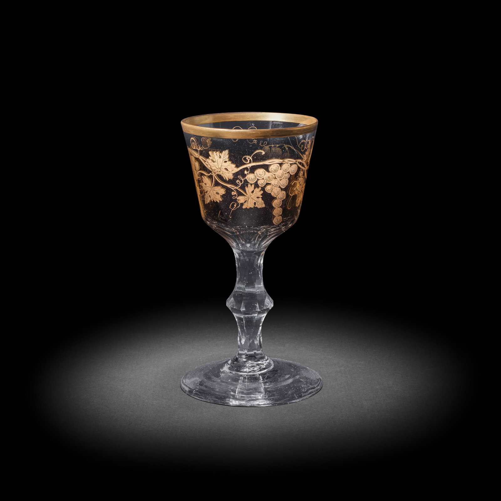 A fine Giles gilded facet stem goblet, circa 1770: A fine Giles gilded facet stem goblet, circa 1770 The generous ogee bowl decorated with a meandering branch of fruiting vine, a gilt band to the rim, the base cut with circlets and facets extending in