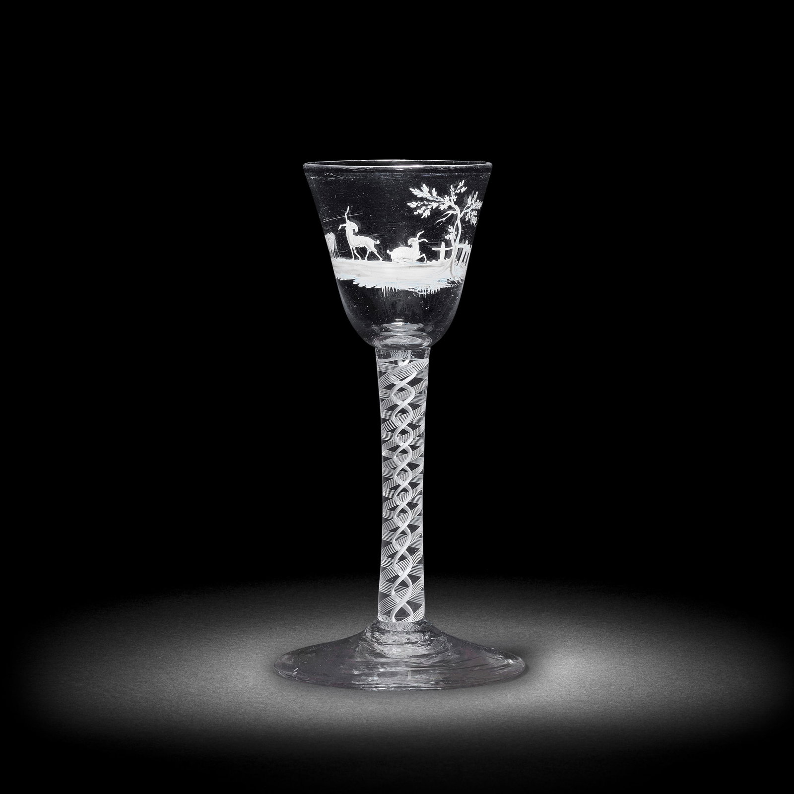 A rare Beilby enamelled opaque twist wine glass with a pastoral scene, circa 1765: A rare Beilby enamelled opaque twist wine glass with a pastoral scene, circa 1765 The round funnel bowl painted in opaque white with a landscape featuring a sheep and two goats with amusingly long hor