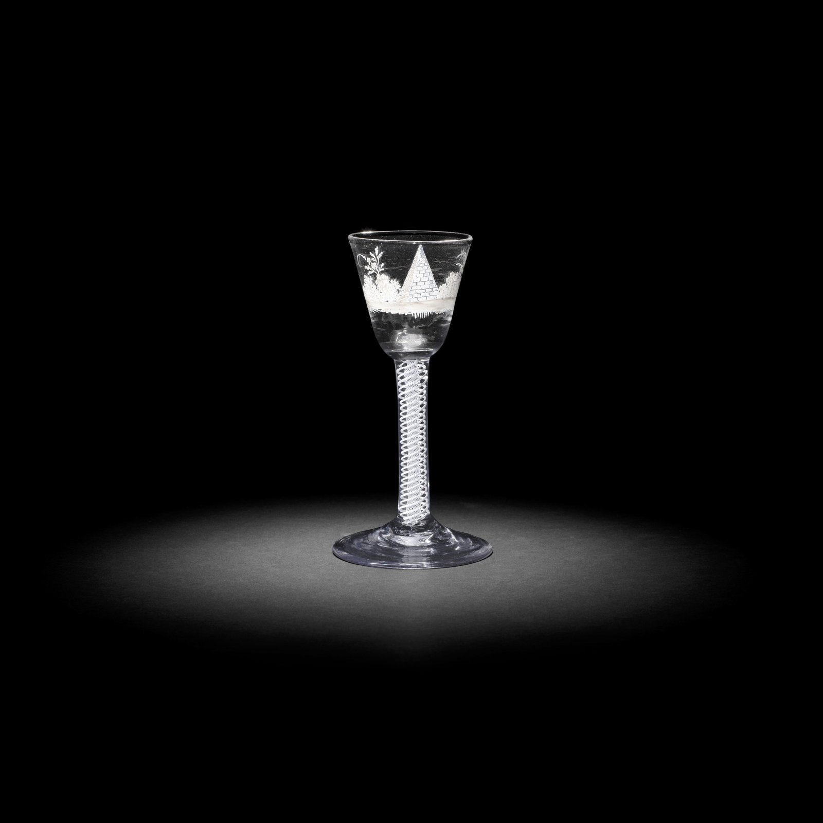 A fine and rare Beilby enamelled opaque twist wine glass with a pyramid, circa 1765: A fine and rare Beilby enamelled opaque twist wine glass with a pyramid, circa 1765 The round funnel bowl painted in opaque white with a pyramid in a bosky landscape, the double-series stem with two p