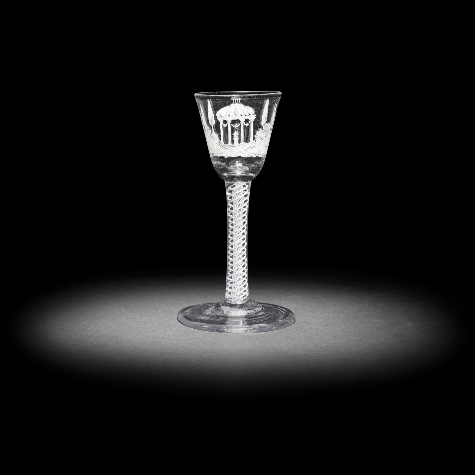 A very rare Beilby enamelled opaque twist wine glass with a pavilion, circa 1765: A very rare Beilby enamelled opaque twist wine glass with a pavilion, circa 1765 The round funnel bowl finely painted in opaque white enamel with an urn displayed on a pedestal within an elaborate neo