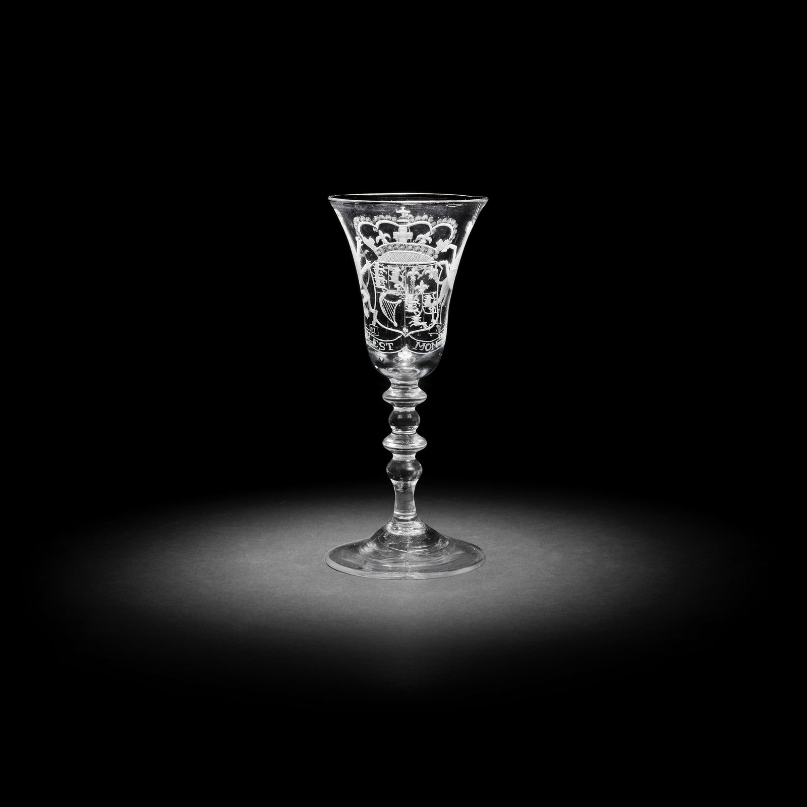 A Dutch engraved Royal armorial light baluster wine glass, circa 1750: A Dutch engraved Royal armorial light baluster wine glass, circa 1750 The bell bowl with the English arms of Anne, Princess Royal and Princess of Orange, supported by the lion and the unicorn, resting