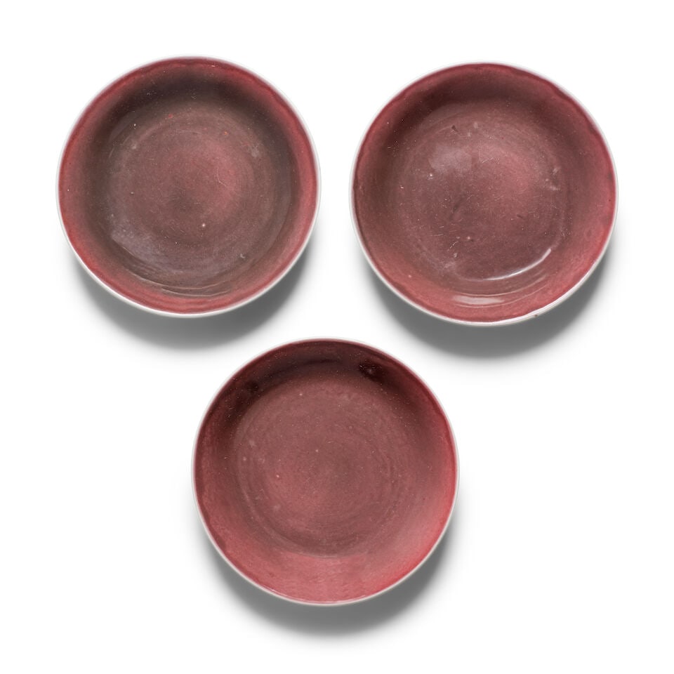 THREE COPPER-RED-GLAZED SMALL DISHES Qianlong marks and of the period (3): THREE COPPER-RED-GLAZED SMALL DISHES Qianlong marks and of the period The base of each with a six-character Qianlong mark in underglaze-blue. 5 7/8in (15cm) diam of each