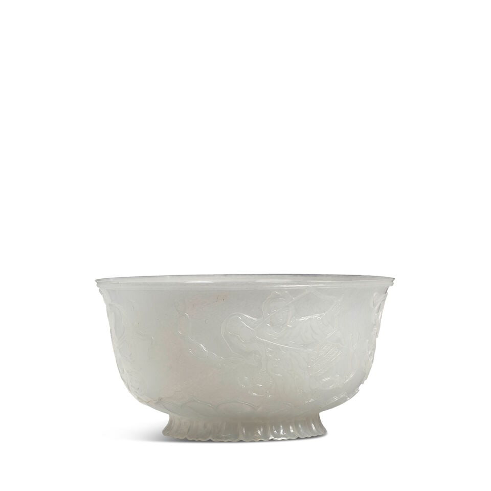 A WHITE JADE MUGHAL-STYLE 'APSARA' BOWL 20th century (box): A WHITE JADE MUGHAL-STYLE 'APSARA' BOWL 20th century 4 3/4in (12cm) diam (box). Footnotes: 二十世紀 白玉雕痕都斯坦式飛