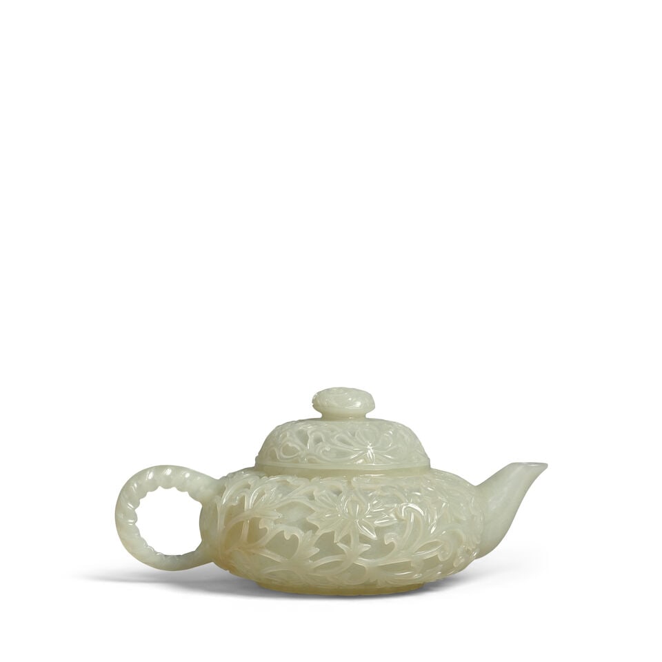 A PALE-CELADON JADE MUGHAL-STYLE SMALL TEAPOT AND COVER 20th century: A PALE-CELADON JADE MUGHAL-STYLE SMALL TEAPOT AND COVER 20th century 5 1/8in (13cm) long Footnotes: 二十世紀 青白玉雕痕都斯坦
